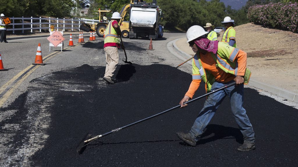 Construction Workers Paving Road
