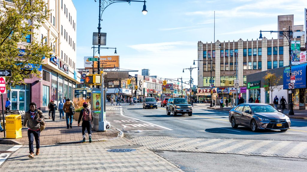 People crossing street in Fordham Heights center, New York City