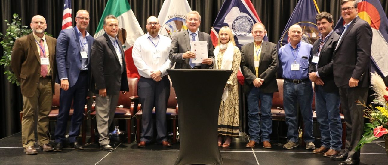 The Secretary of Economic Development for the State of Baja California, Mexico, Carlo Bonfante, center,holds the memorandum of understanding incorporating Baja California into the Western States and Tribal Nations initiative at the Uintah Basin Energy Summit in Vernal, UT.