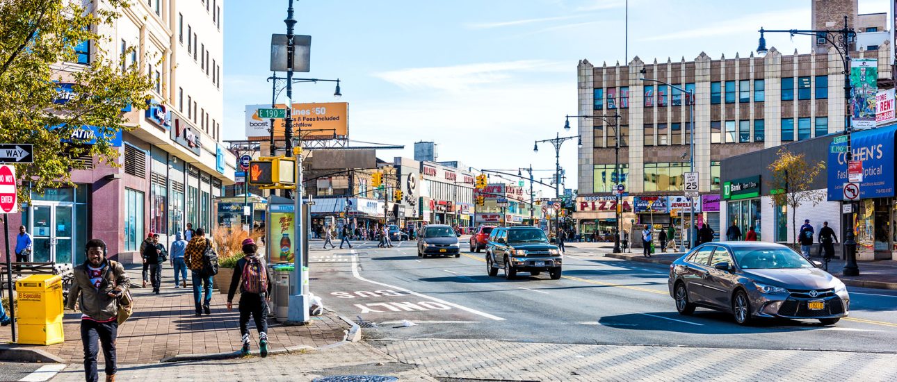 People crossing street in Fordham Heights center, New York City