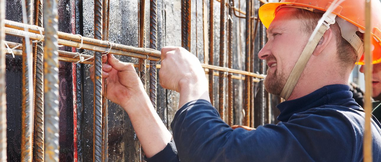Construction worker tying rebar