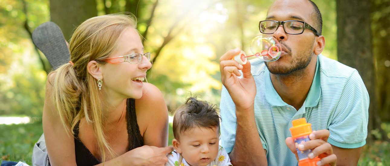 Family Outside Blowing Bubbles