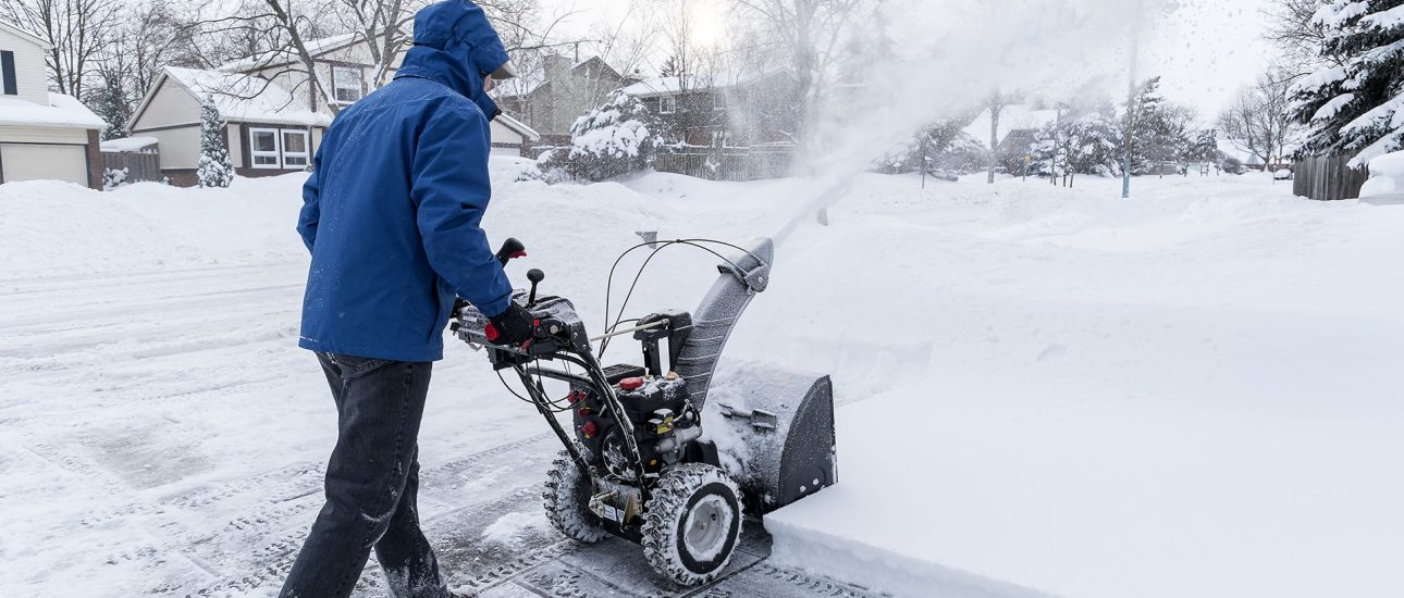 Man clearing snow with a snow blower