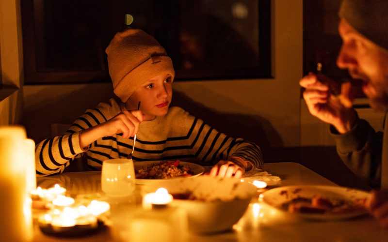 family eating by candlelight