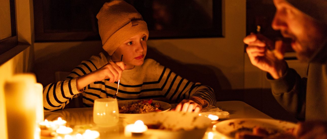 family eating by candlelight