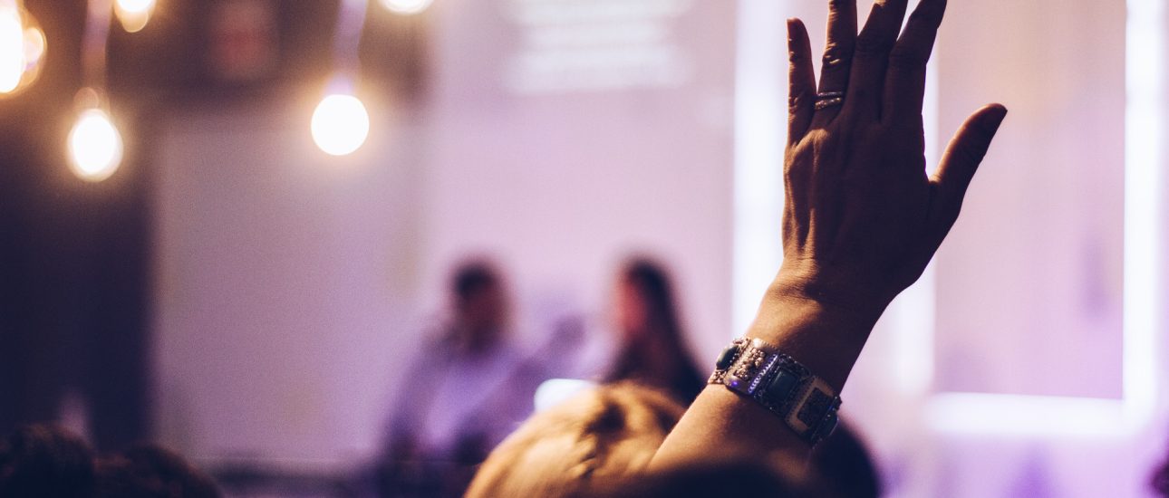 Woman raising hand to speak