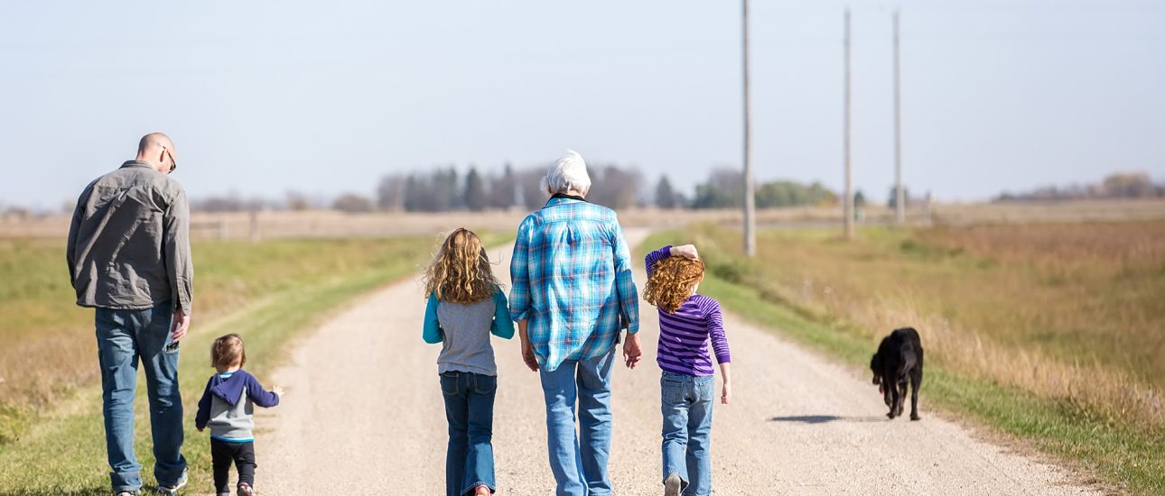 Family Walking Down Rural Gravel Driveway