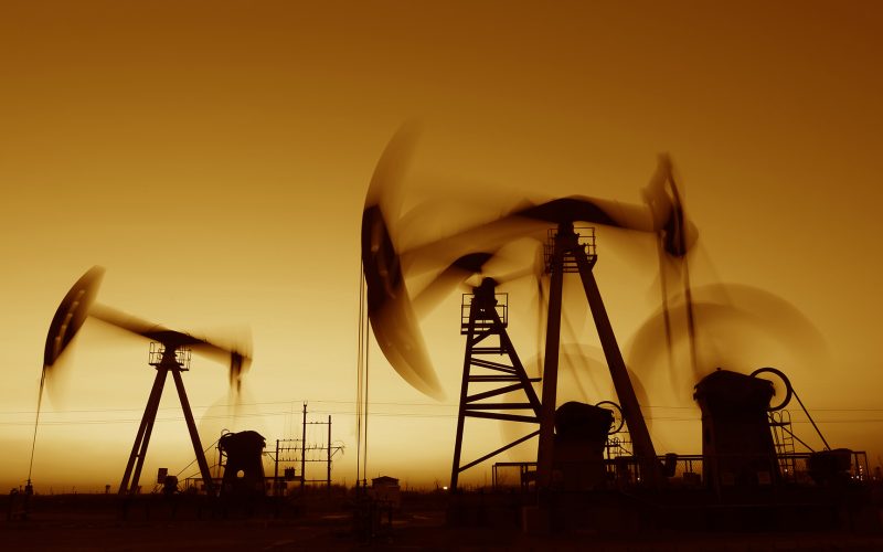 Oil derricks at sunset