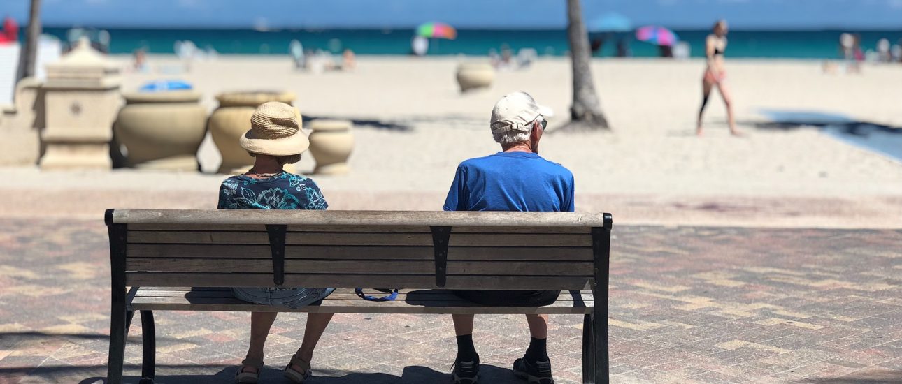 Adults on a beach bench
