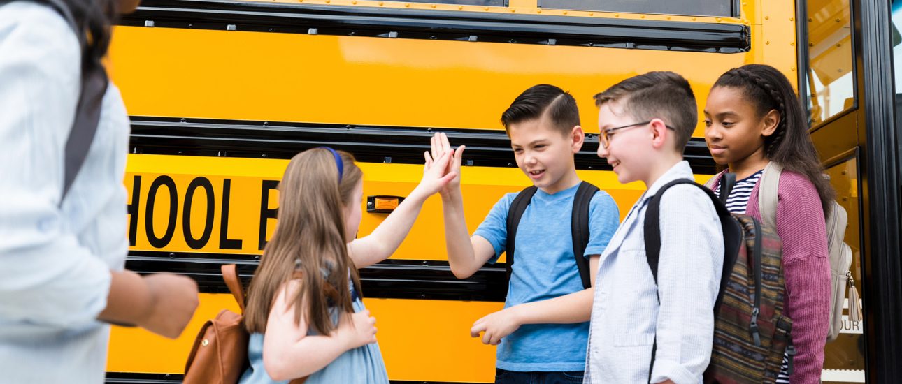 Children going back to school on a bus