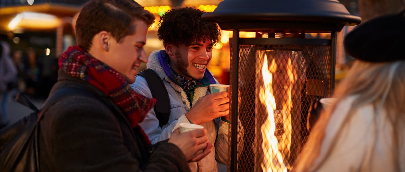 Friends Gathered Around Outdoor Heater
