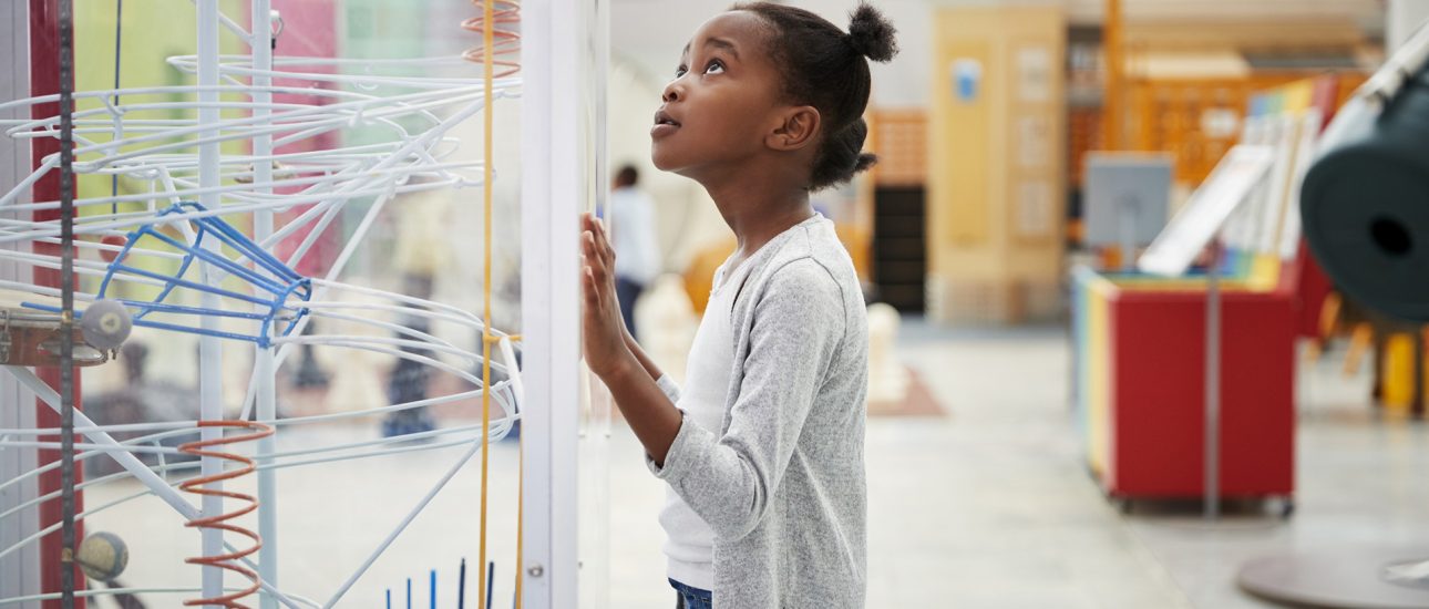 Young Girl Looking At Science Exhibit